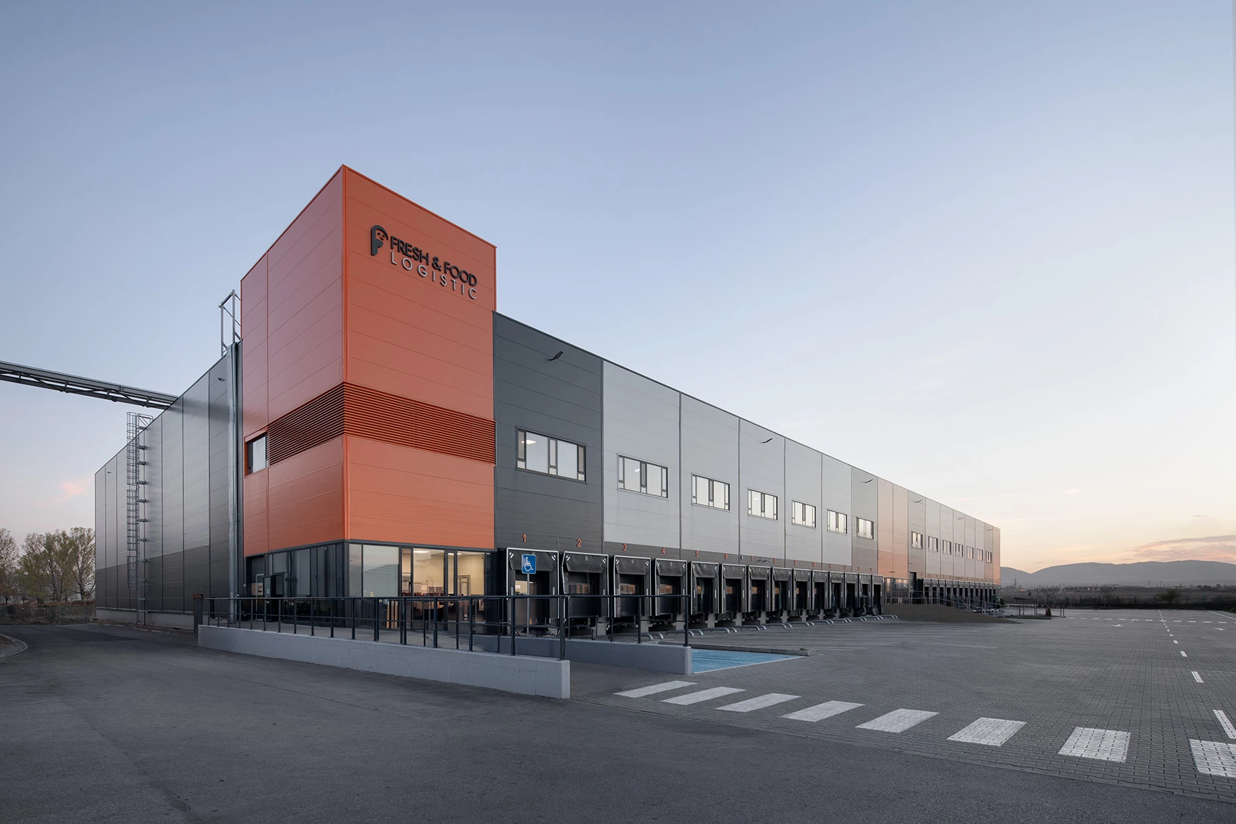 General view of the Fresh&Frozen logistics and warehouse facility in Sofia with loading docks and orange facade accent