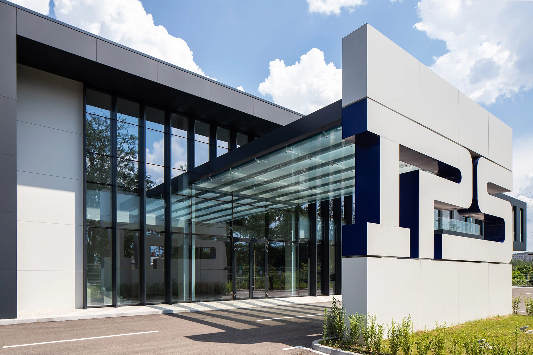 Main entrance of the IPS Production Complex in Kardzhali with glazed facade and entrance canopy