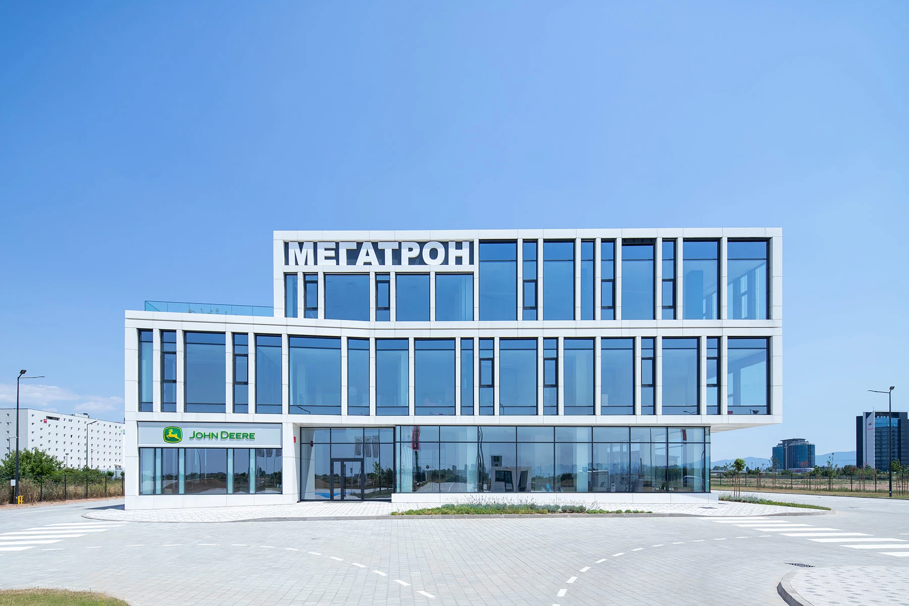 Фронтален изглед към централния офис на Megatron в София с остъклена офис фасада и сервизна сграда