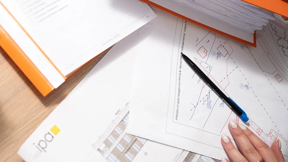 Review of project documentation and a planning drawing with marked property boundaries