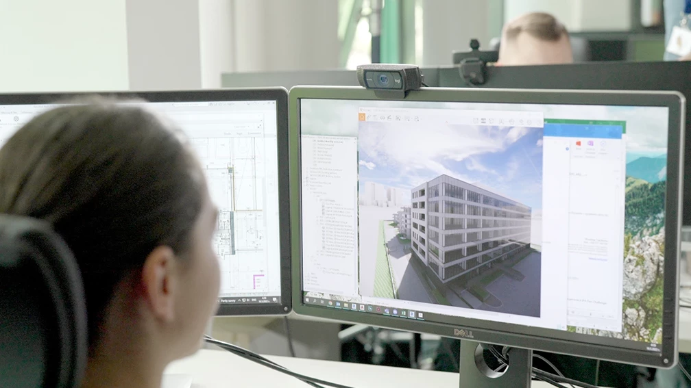 Architectural model of a multistory building displayed on a design workstation