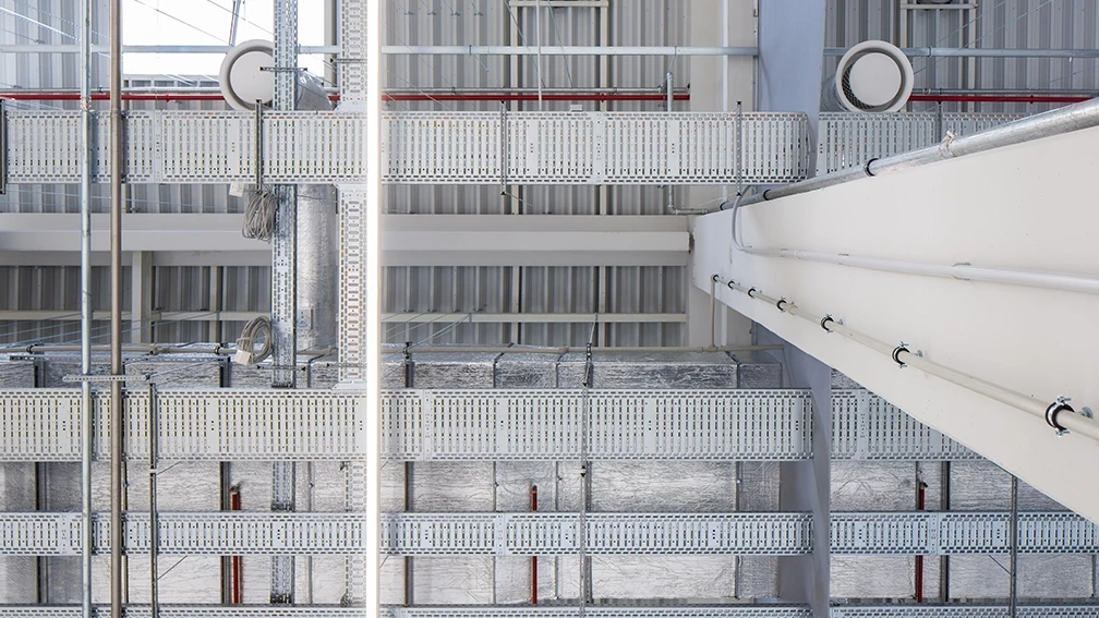 Metal cable trays and electrical routes in an industrial building