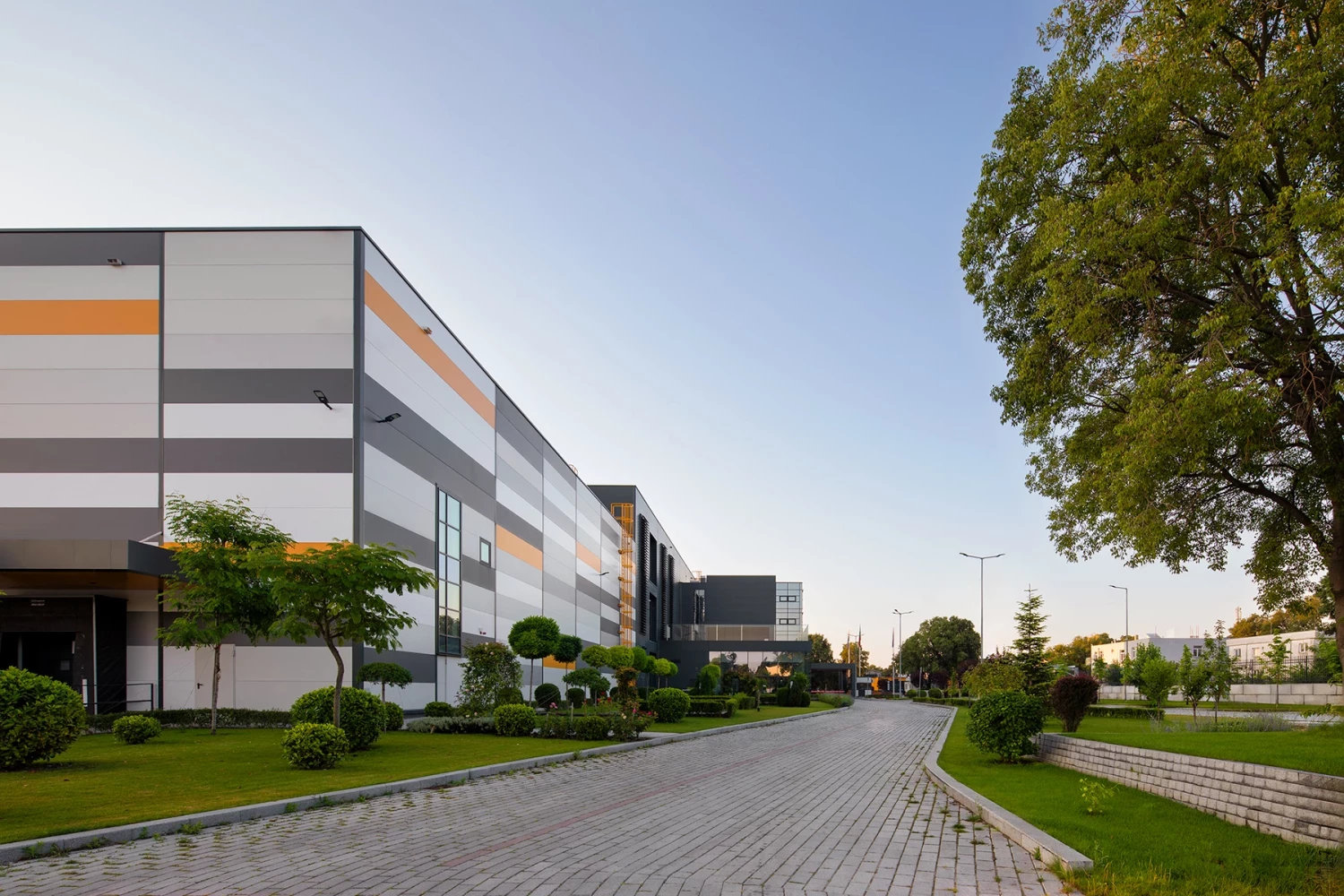 AREON production building with horizontally articulated facade and landscaping
