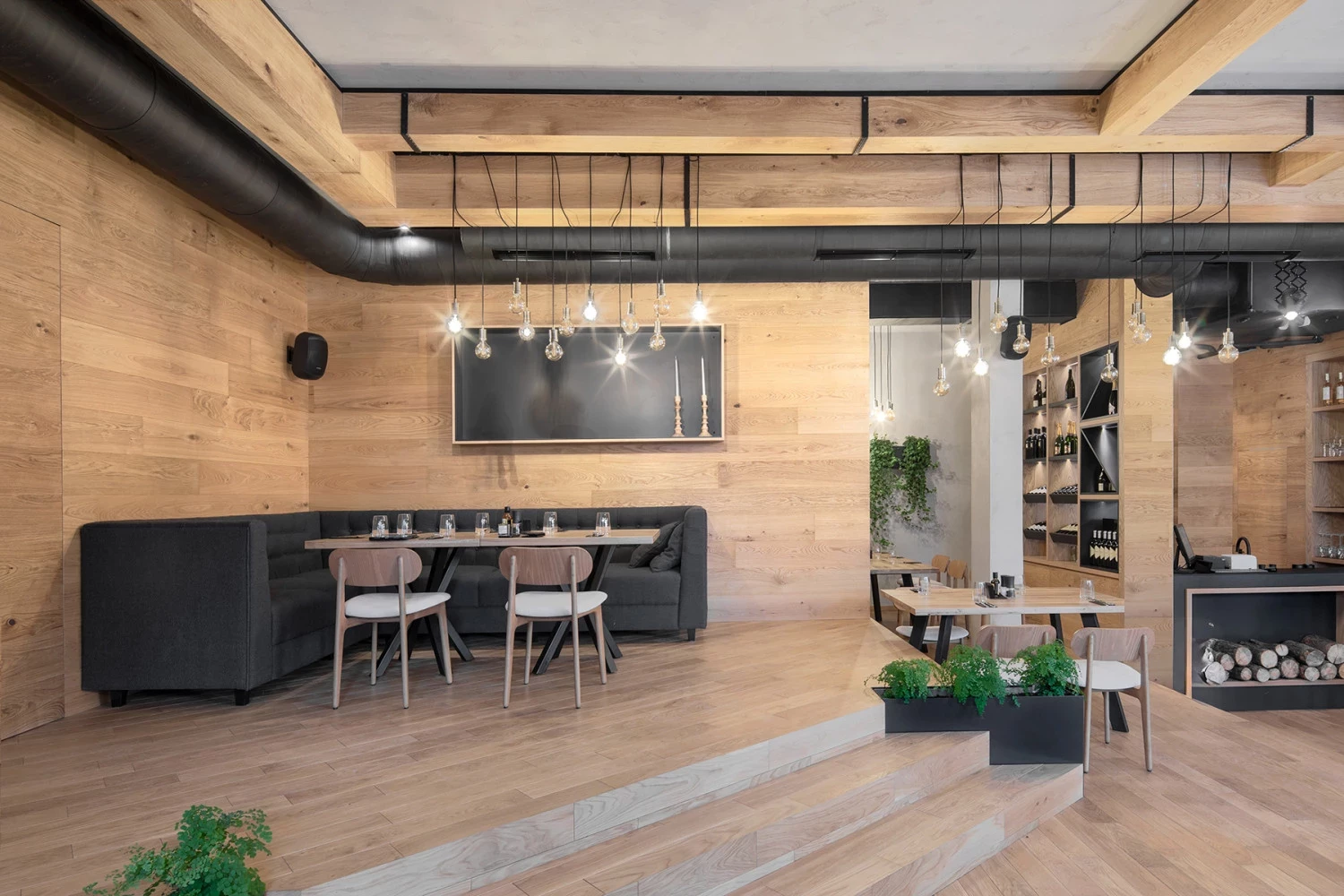 Bella Vista interior with wood wall, dining tables, and decorative lighting