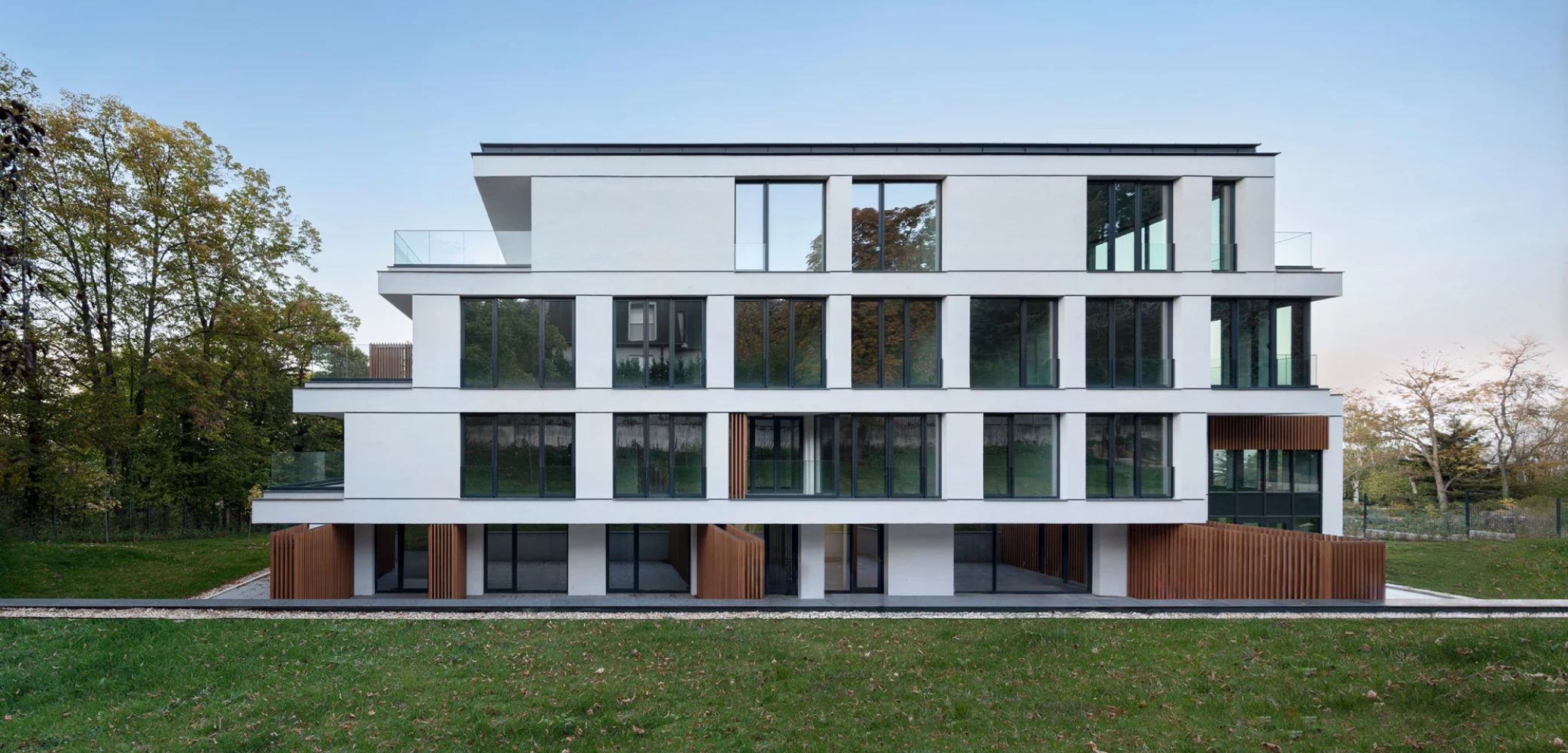 Residential facade of Boyana Senses with large windows facing the landscaped area