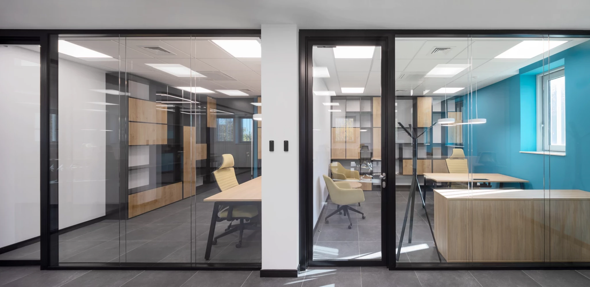 Workspaces in the CSC administrative building with glazed office partitions