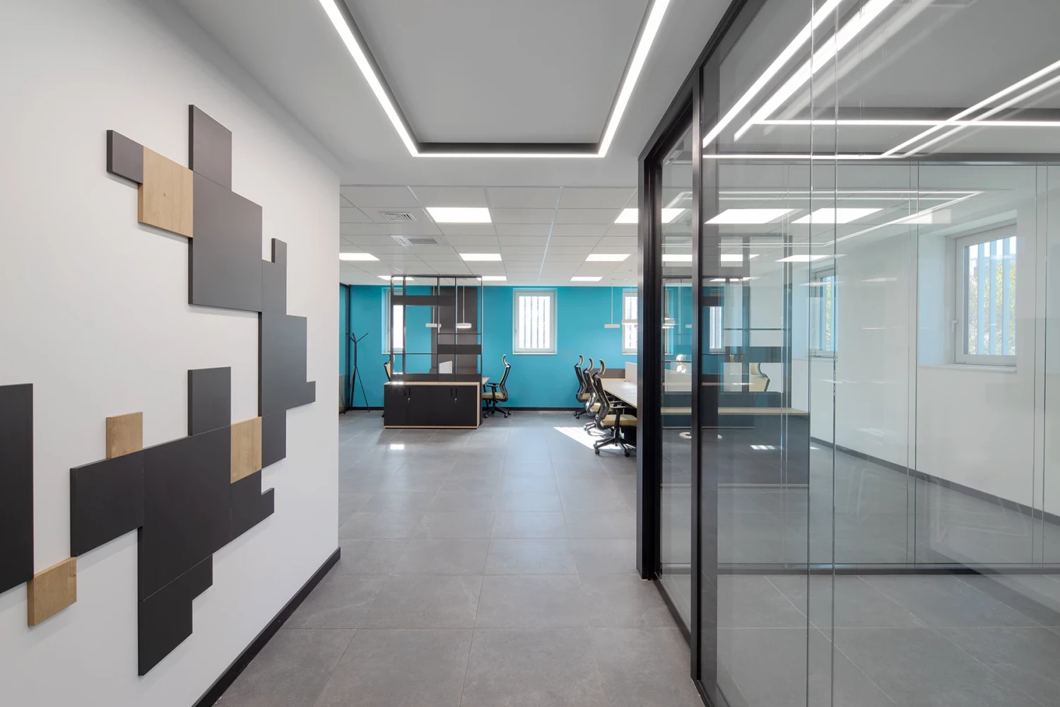 Corridor in the CSC administrative building with glazed rooms and geometric wall accents