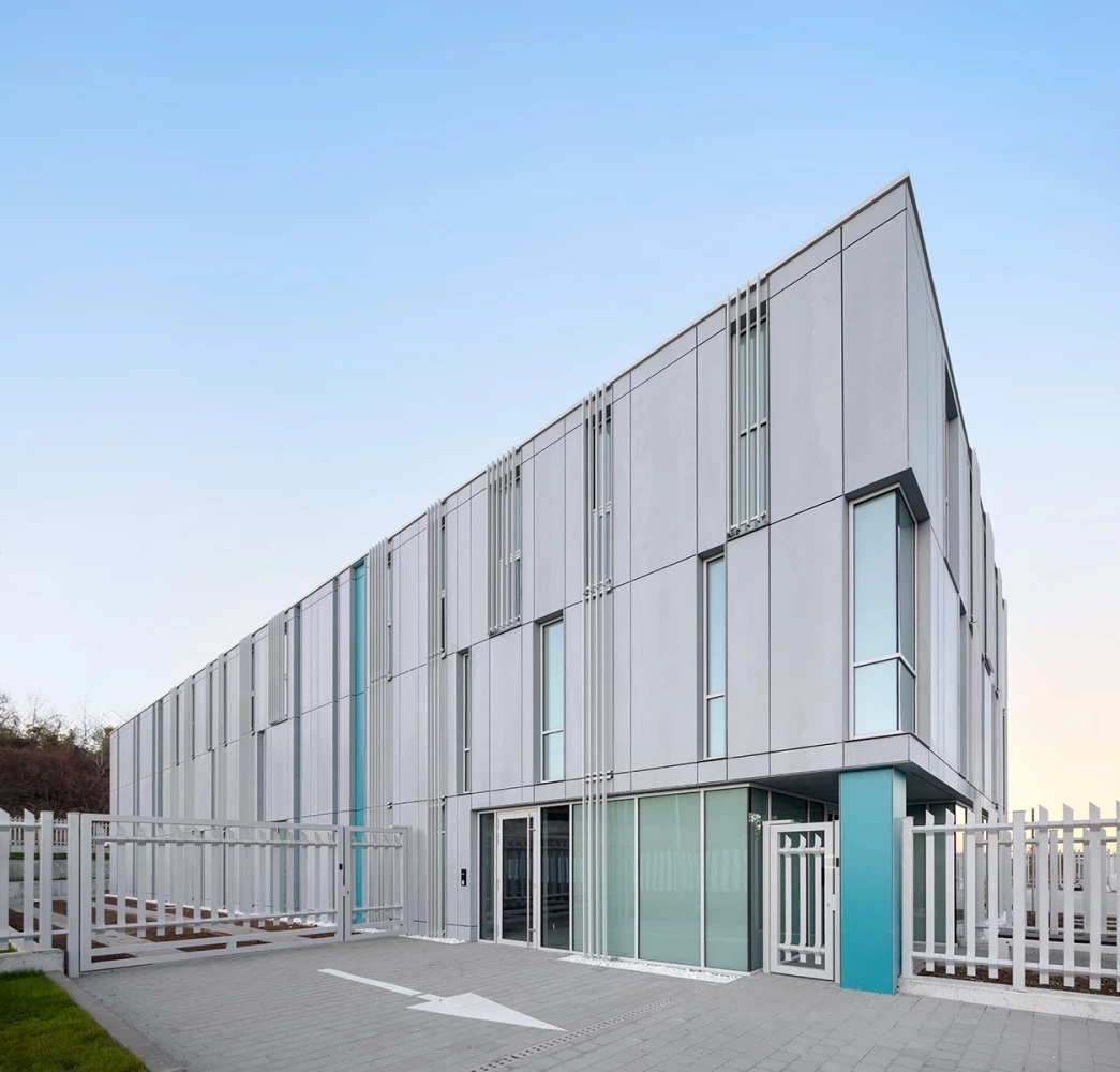 Corner view of the CSC administrative building with metal facade and glazed entrance