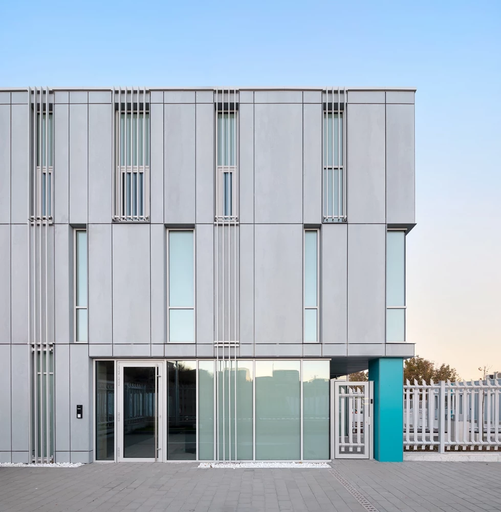 Main entrance of the CSC administrative building with vertical facade panels