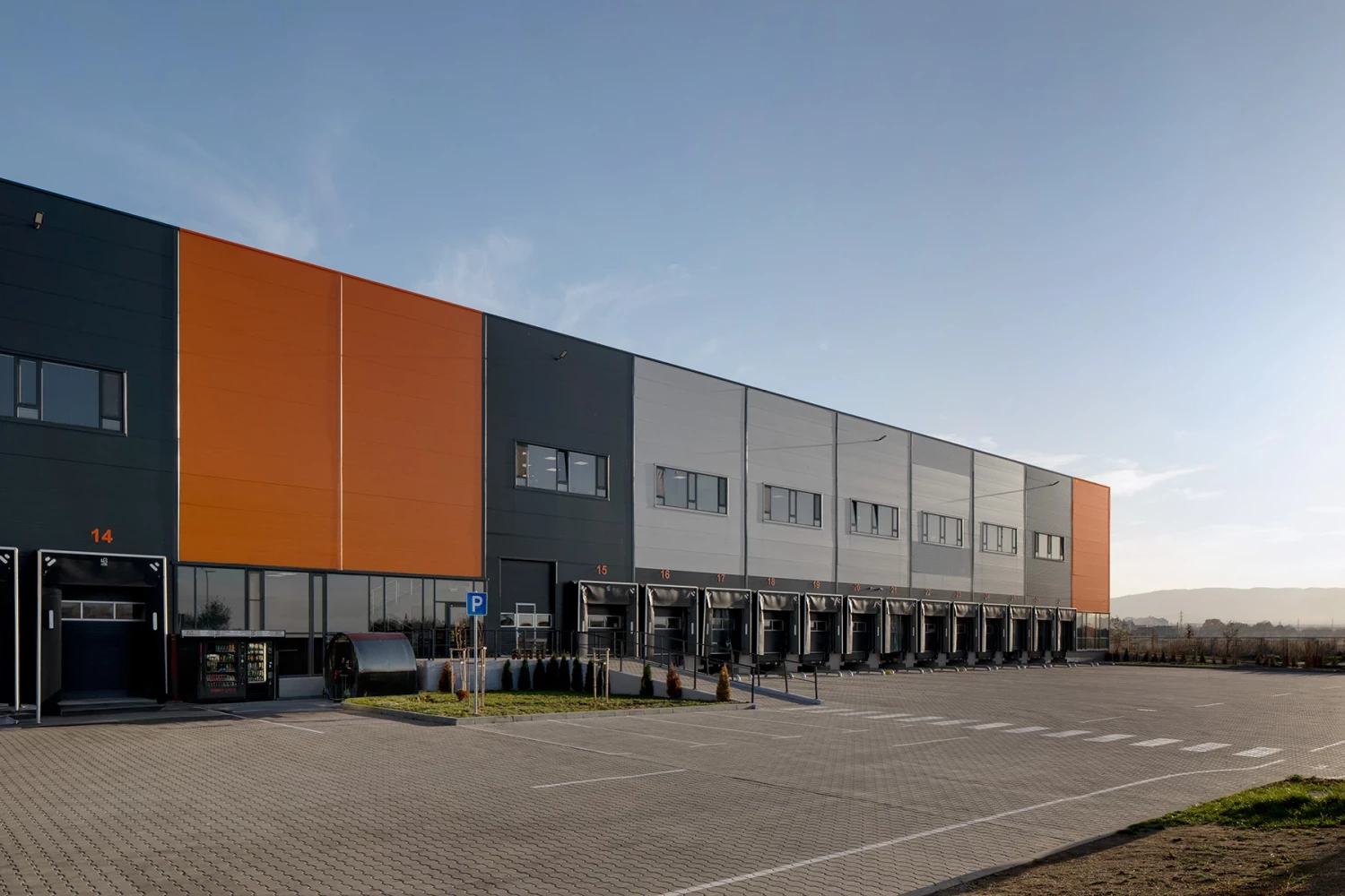 Facade of the Fresh&Frozen logistics and warehouse facility with a row of loading docks