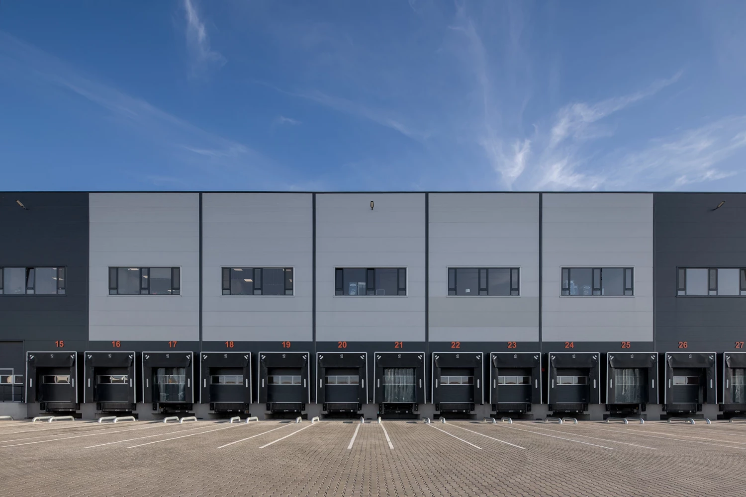 Long facade of the Fresh&Frozen warehouse facility with a continuous row of loading docks