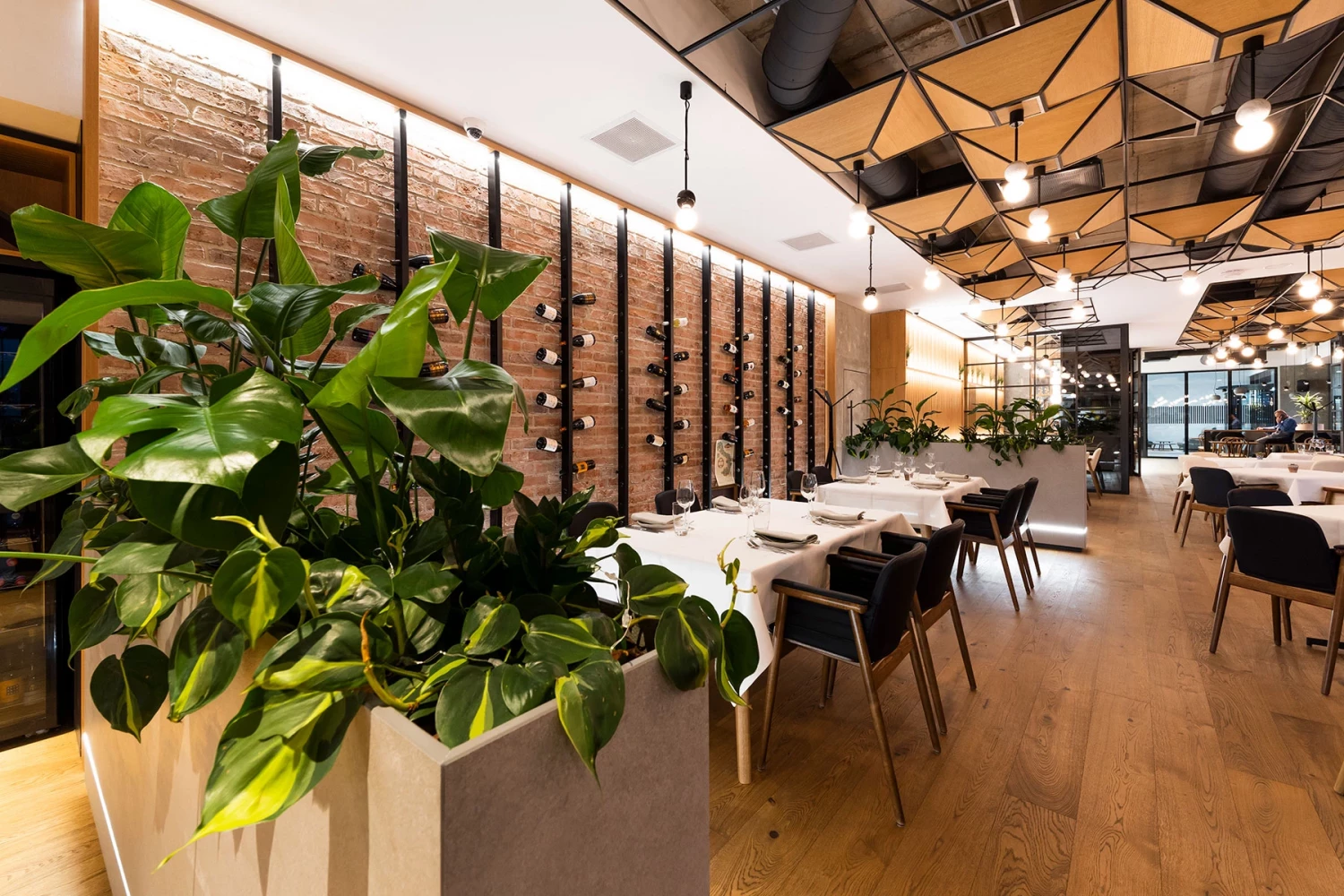 Interior of GORA Restaurant with natural greenery and a long seating area