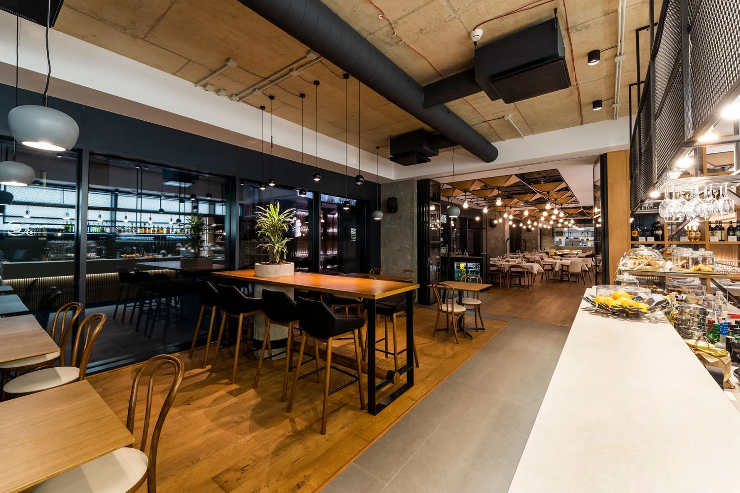 Bar area and open kitchen in the interior of GORA Restaurant in Sofia