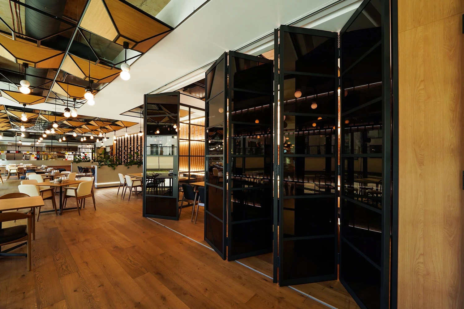 Interior of GORA Restaurant with dark decorative partition and dining area