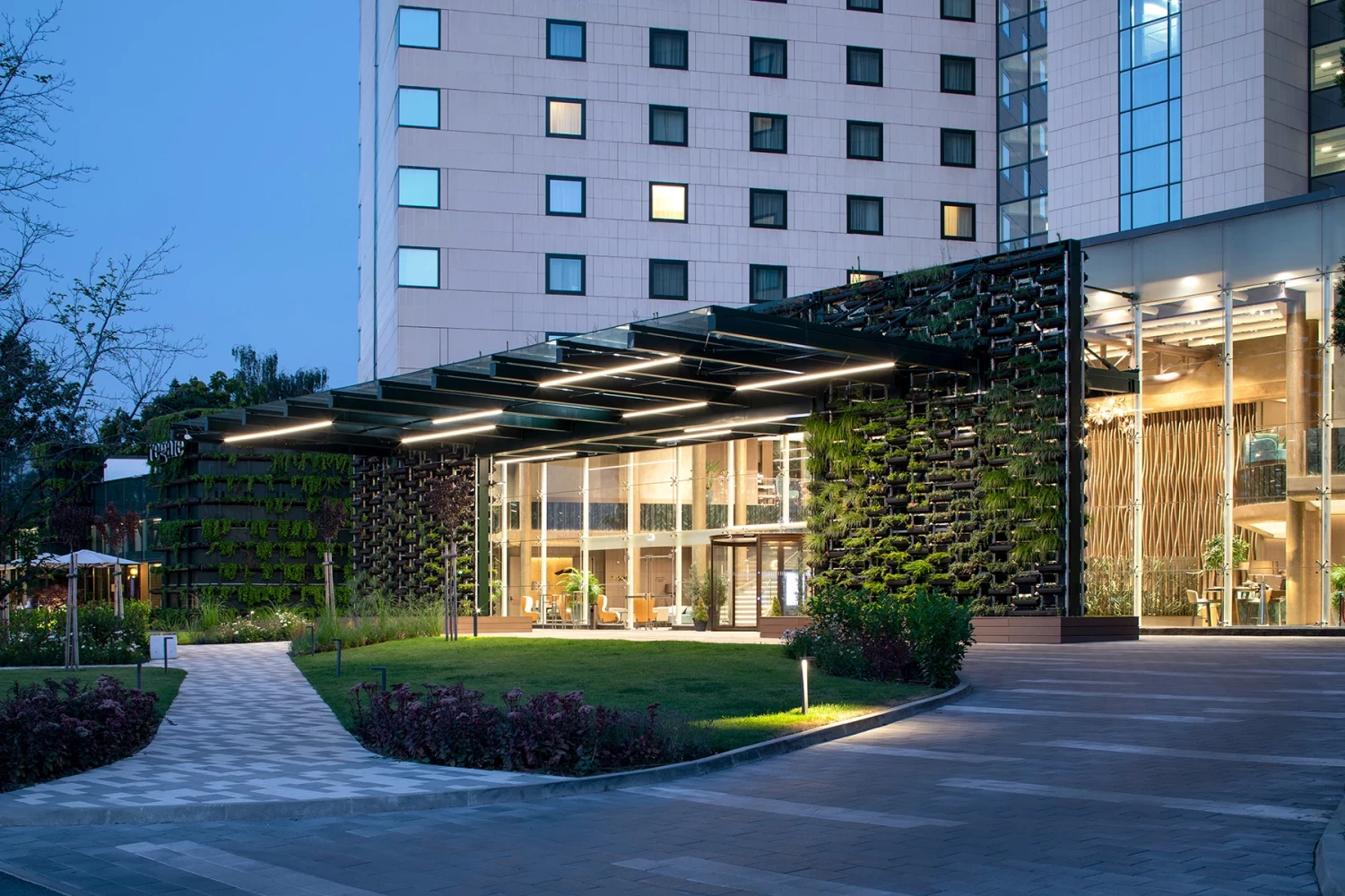 Evening view of the renovated main entrance of Hilton Sofia with vertical green walls