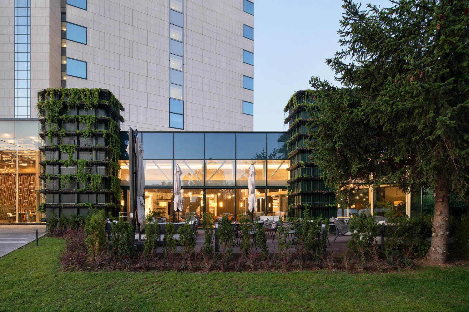 Renovated glazed section of Hilton Sofia with vertical greenery and landscaped surroundings