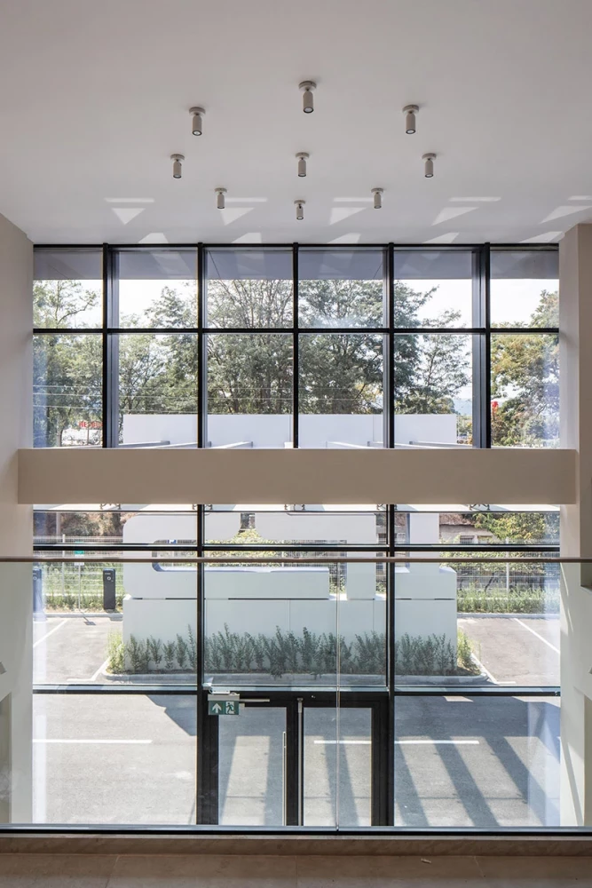Interior of a glazed space in the administrative area of the IPS Production Complex