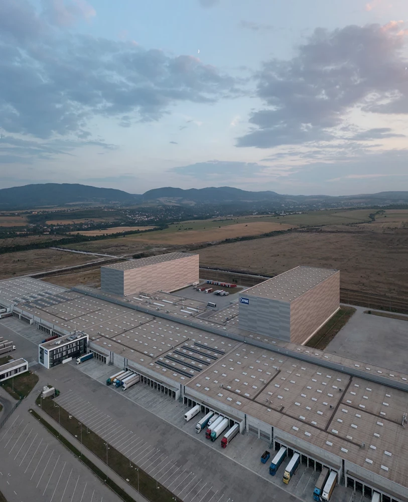 Aerial view of the high-bay warehouses and roofs of the JYSK Logistics Base