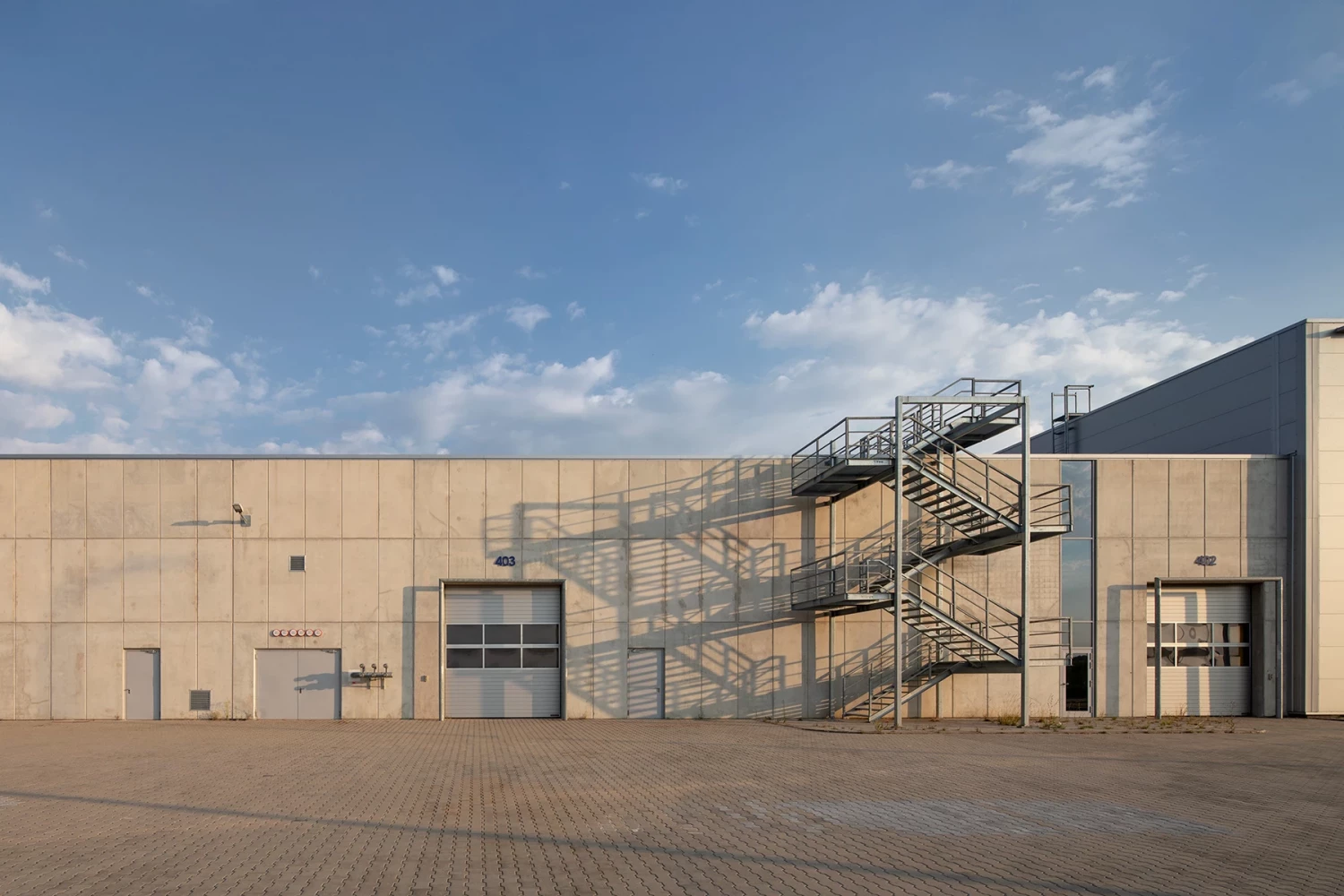 Facade of the JYSK Logistics Base with exterior stairs and technical areas
