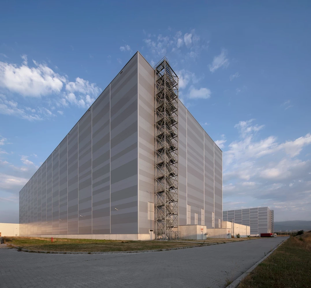 High-bay warehouse at the JYSK Logistics Base with a tall metal facade