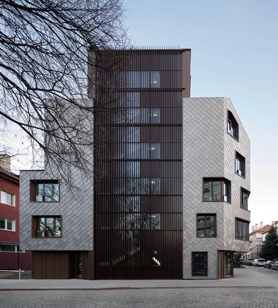 Side facade of KA11 with vertical louvers and titanium-zinc cladding
