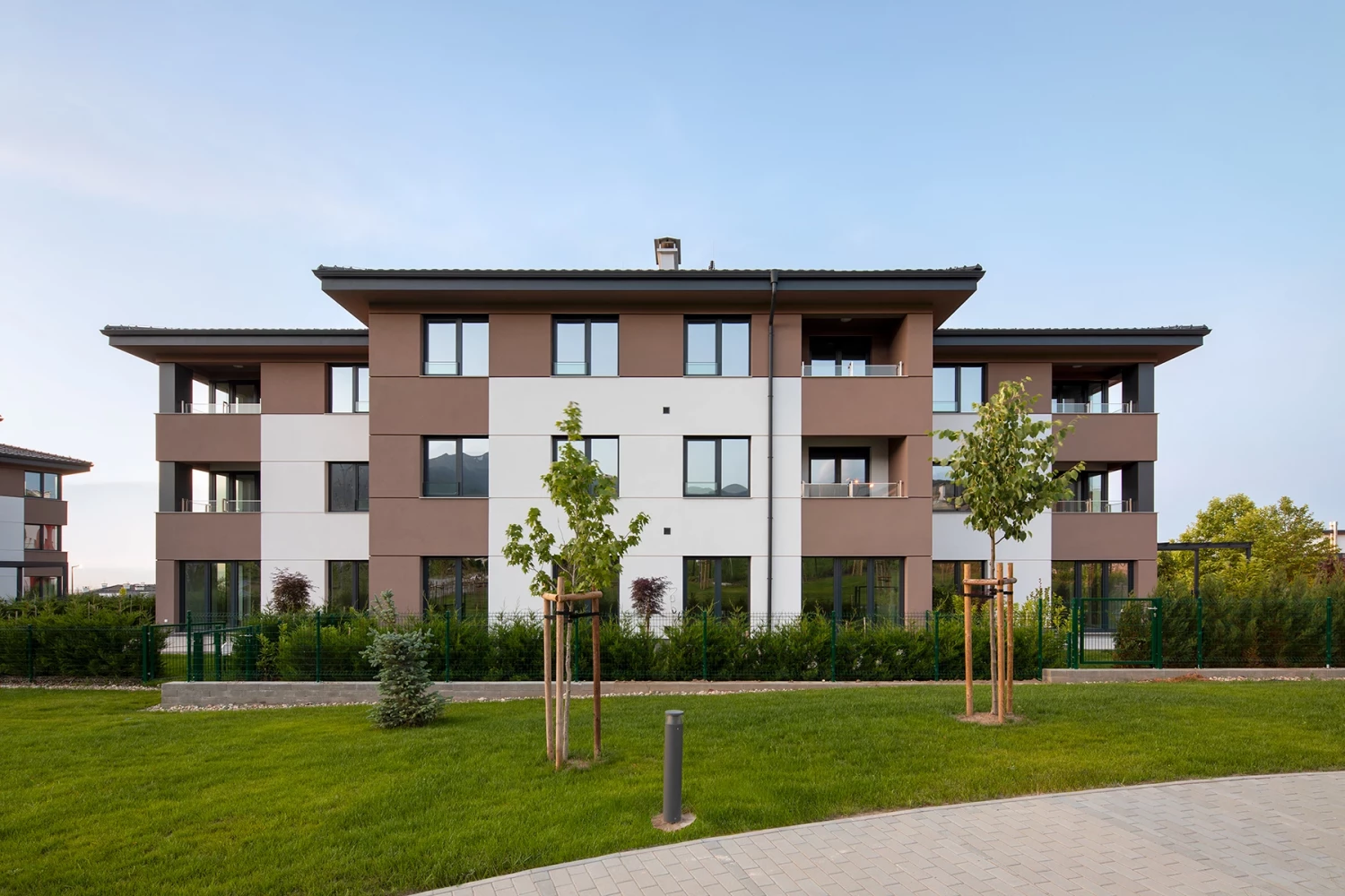 Front view of a residential building at Residential Park Sofia Phase 3B and the adjacent green area