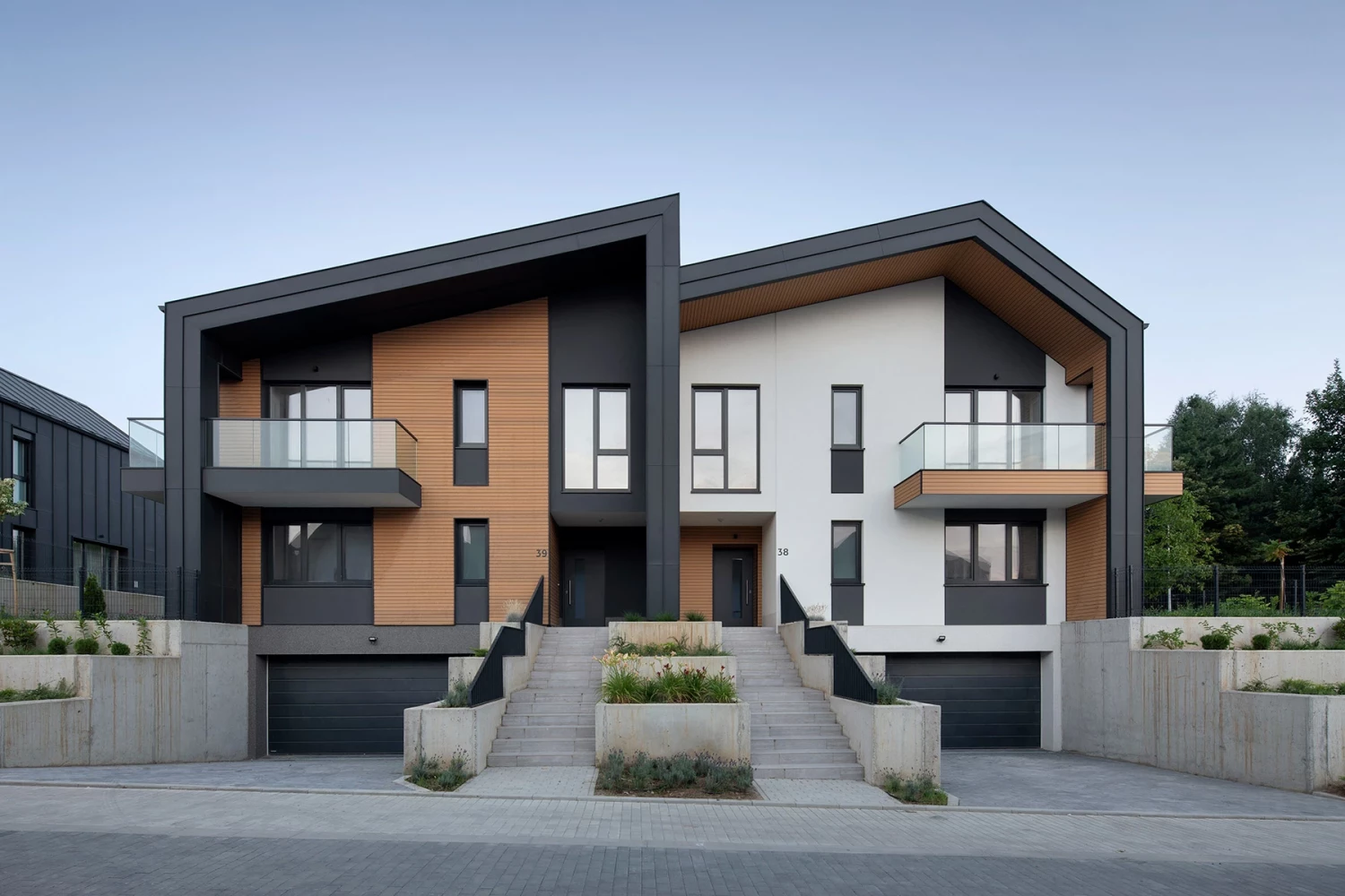 Residential building with pitched roof and timber facade accents at River Park