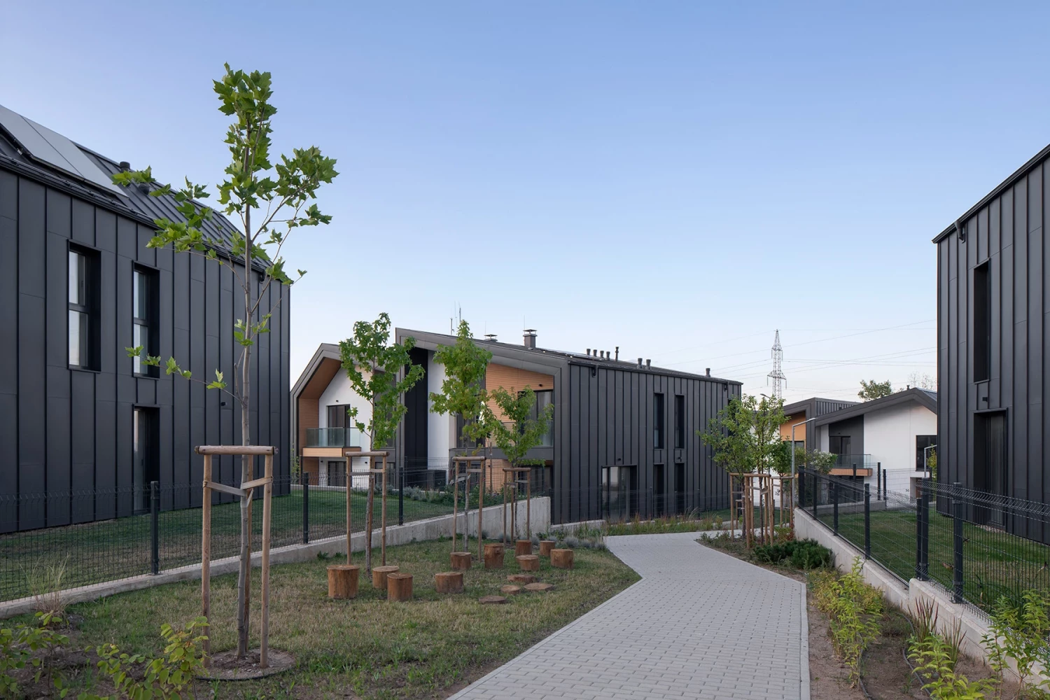 Landscaped pedestrian walkway between residential buildings at River Park
