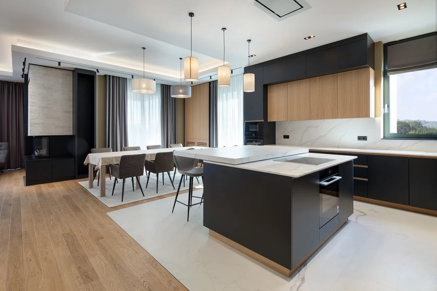 Kitchen in the SPV house with an island, dark cabinetry, and wood finishes