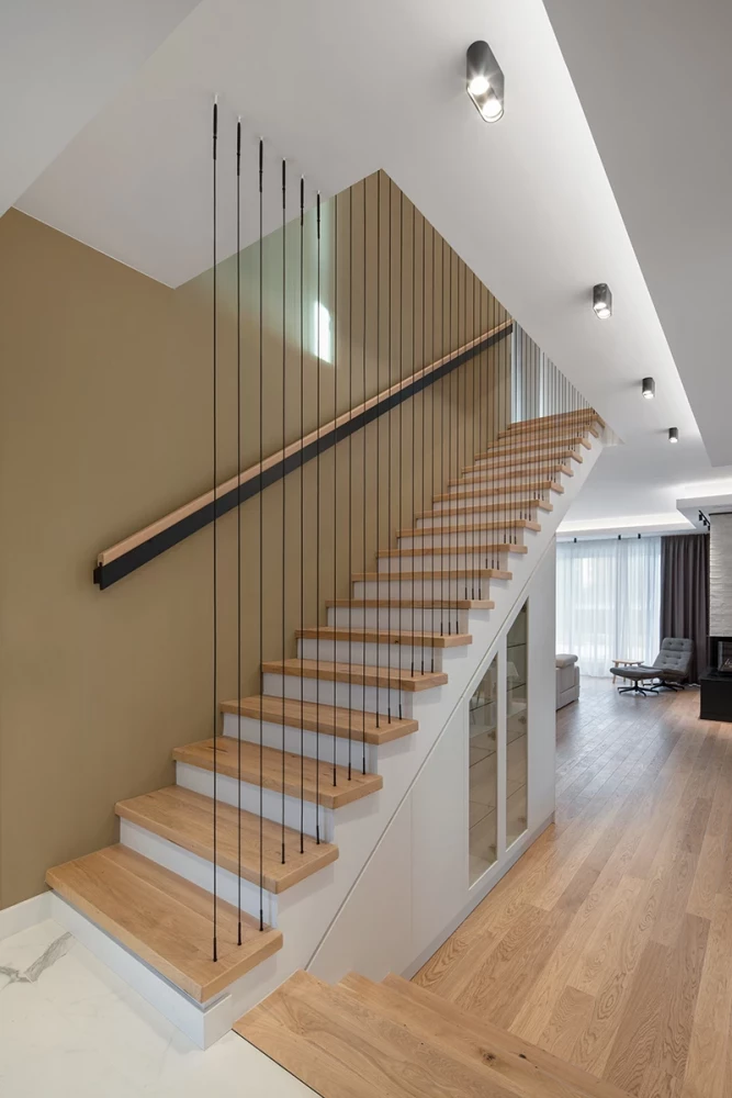 Staircase in the SPV house with wood treads and vertical metal railing