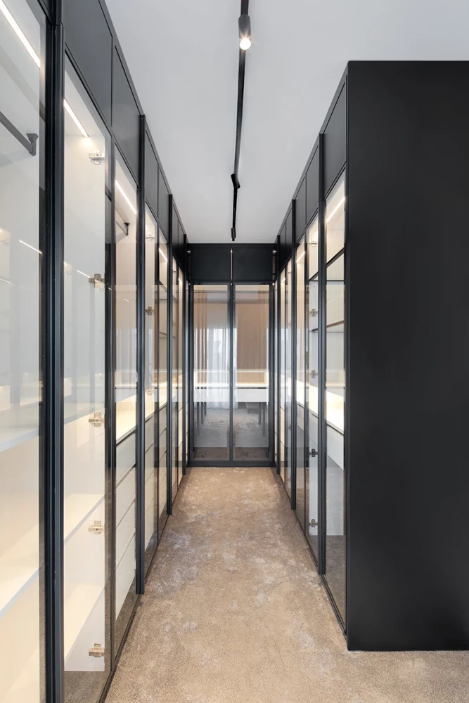 Glazed interior corridor in the SPV house with black metal frames