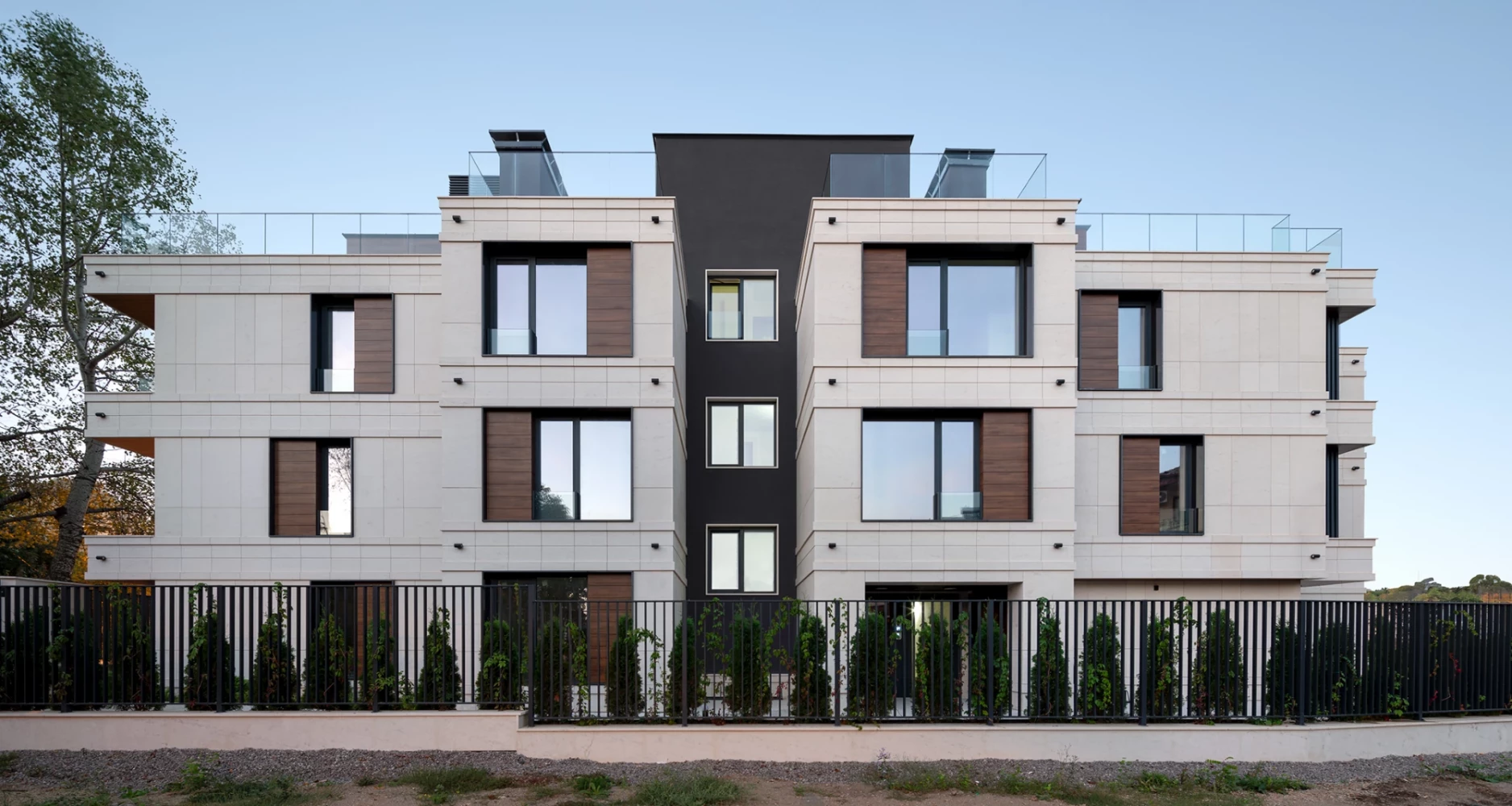 Main facade of Sunset Garden with contrasting dark accents and stone cladding