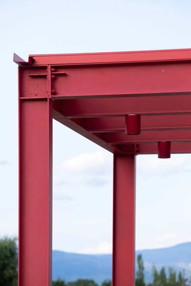 Detail of the red steel canopy at the VolaPlast production facility
