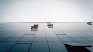 Glazed facade of GORA Business Center viewed from ground level