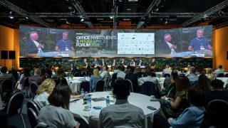 Wide view of the Office Investments & Workspace Forum 2025 panel and audience