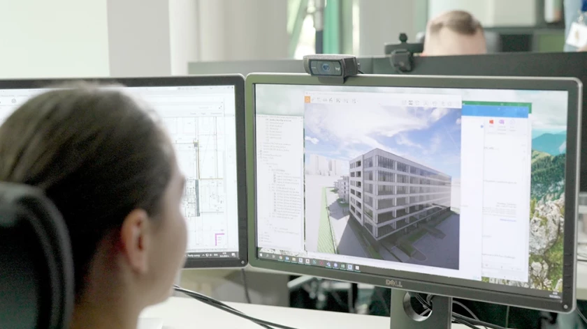 Architectural model of a multistory building displayed on a design workstation