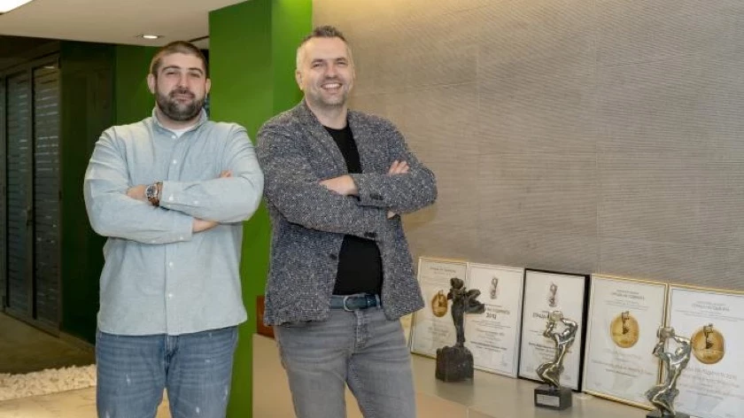 Two IPA - Architecture and more representatives standing beside awards in the office